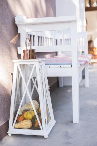 a container of fruit and vegetables next to a bench at Nefelejcs Vendégház in Tóalmás
