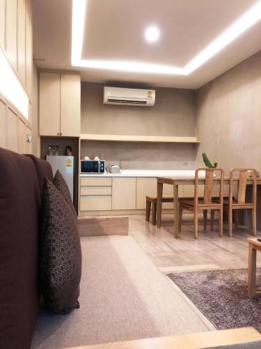 a kitchen and dining room with a table and chairs at Chu Hotel in Chiang Mai