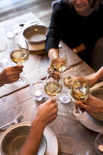 a group of people sitting at a table with wine glasses at HOTEL SEPP - Alpine Boutique Hotel - Adults Only ab 21 Jahre in Maria Alm am Steinernen Meer