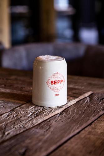 a coffee cup sitting on top of a wooden table at HOTEL SEPP - Alpine Boutique Hotel - Adults Only ab 21 Jahre in Maria Alm am Steinernen Meer