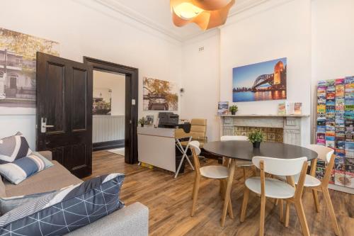 a living room with a table and a couch at Dalziel Lodge in Sydney