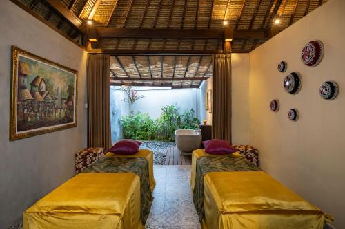 Ένα ή περισσότερα κρεβάτια σε δωμάτιο στο Arya Villas Ubud