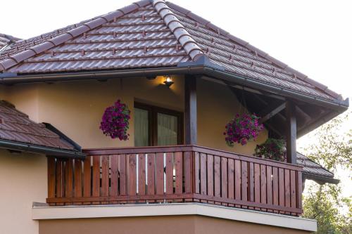 a balcony of a house with flowers on it at Apartment Ivan & Iva in Gornji Vaganac