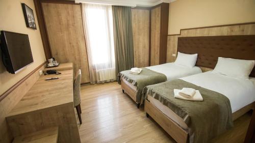 Кровать или кровати в номере Hotel Juralius