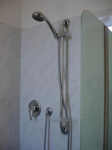 a shower with a glass door in a bathroom at Petit Hotel in San Benedetto del Tronto