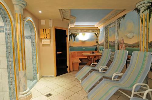 a bathroom with chairs and a table in a room at Hotel Gasthof Stoanerhof in Mayrhofen