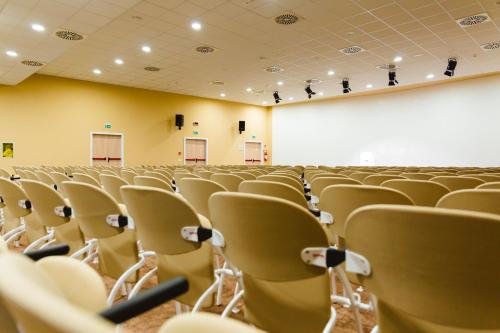 an empty lecture hall with empty chairs in it at Torre Cintola Greenblu Sea Emotions in Monopoli