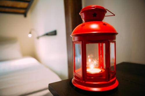 a red lantern sitting on a table with a candle at Kuree Hut in Semporna