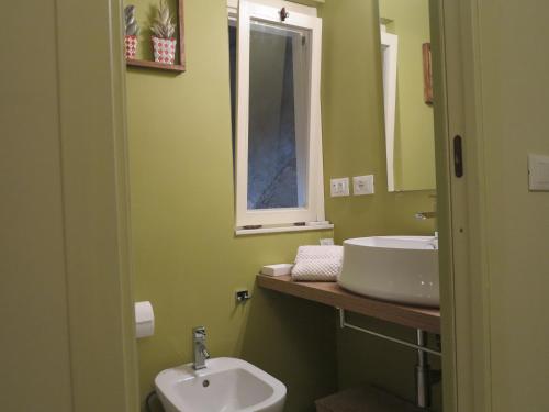 a bathroom with a sink and a toilet and a mirror at La Piccola Dimora in Tivoli
