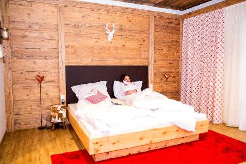 a person laying in a bed in a bedroom at Plus Punkt Private Spa in Weingarten