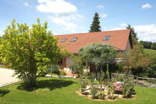 a house with a garden in front of it at La Ferme du Cayla in Linac