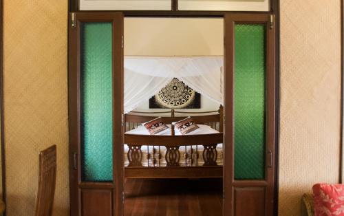 a glass door with a table in a room at Baan Orapin in Chiang Mai