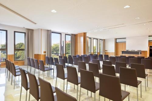 a room with rows of chairs in a room with windows at Best Western Premier CMC Girona in Girona