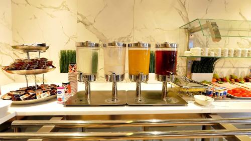 a kitchen counter with a bunch of different colored drinks at St.Joseph Hotel Hamburg - Reeperbahn St.Pauli Kiez in Hamburg