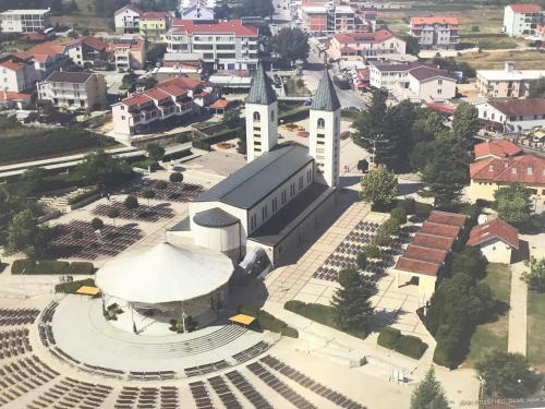 an aerial view of a large building with a church at Apartments Joja in Međugorje