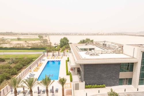 an aerial view of a resort with a swimming pool at Blue Ocean Holiday Homes - Polo Residence C1 in Dubai