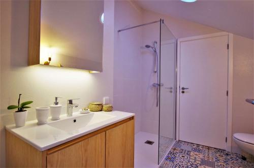 a bathroom with a sink and a shower at Casas do Jardim in Marco de Canavezes
