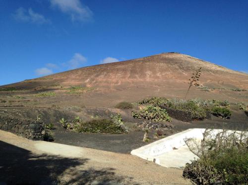 a large hill with a mountain in the background at Patio II studio at finca in La Asomada