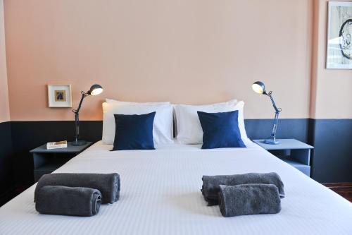 a large white bed with two pillows on it at Gin o clock Apartment 3A in Lisbon