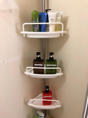 a shelf in a bathroom with toiletries on it at Kurashiki Base Inarimachi in Kurashiki