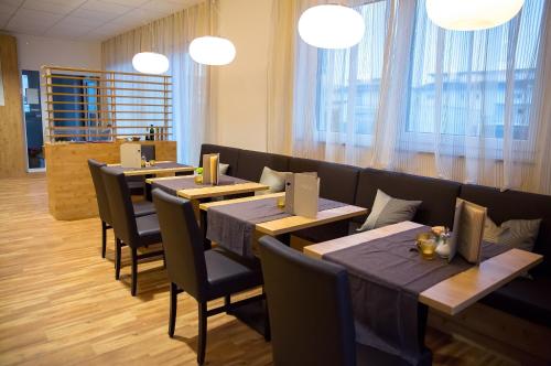 a row of tables and chairs in a restaurant at Plus Punkt Private Spa in Weingarten