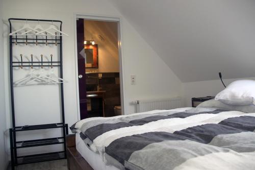 a bedroom with a bed and a closet at Lavendelhof Elsdorf in Elsdorf
