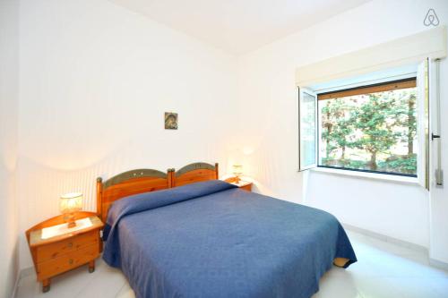 a bedroom with a blue bed and a window at Appartamenti Villa Maria in Ischia