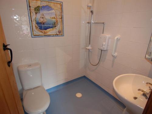 a bathroom with a toilet and a sink at The Milking Parlour in Wookey