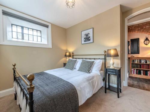 a bedroom with a bed and a window at The Cells in Ingleton 