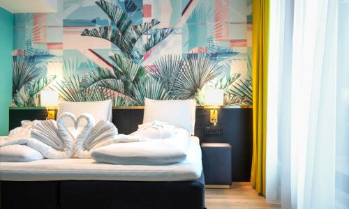 a bedroom with a bed with white towels on it at Thon Hotel Storo in Oslo
