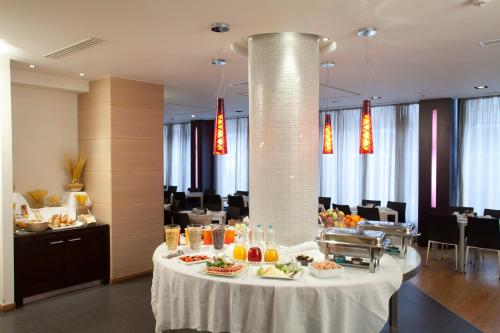 a table with food on it in a restaurant at Domotel Olympia in Thessaloniki