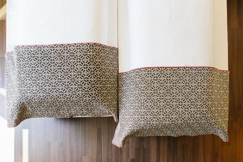 a bed with two pillows on top of it at Chester Hotel Heidelberg in Heidelberg