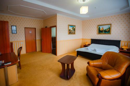 a bedroom with a bed and a couch and a chair at LidoLux in Bălţi