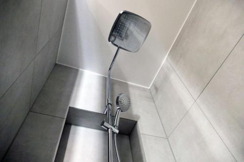 a shower with a shower head in a bathroom at Maximilian in Speyer