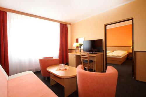 a hotel room with a bed and a mirror at Hotel Strážnice in Strážnice