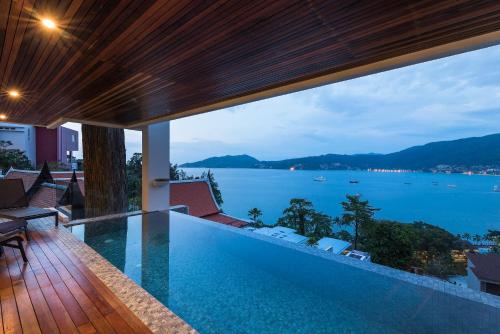 a swimming pool with a view of the water at Jirana Patong in Patong Beach