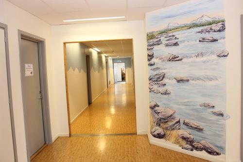 a hallway in an office building with a painting on the wall at STF Östersund Ledkrysset in Östersund