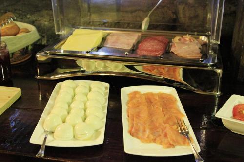 a table topped with plates of food with meat and vegetables at Hótel Tindastóll in Sauðárkrókur