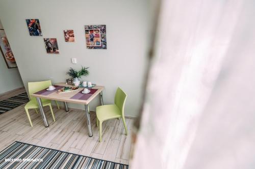 a table and chairs in a room with a table at Brickyard Apartments Cluj in Cluj-Napoca