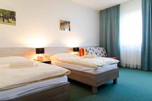 Postel nebo postele na pokoji v ubytování Penzión Uhliská a Depandance Gazdovský dom