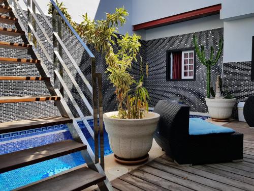 a patio with a pool and a chair and stairs at Casa Los Islas in Playa del Ingles