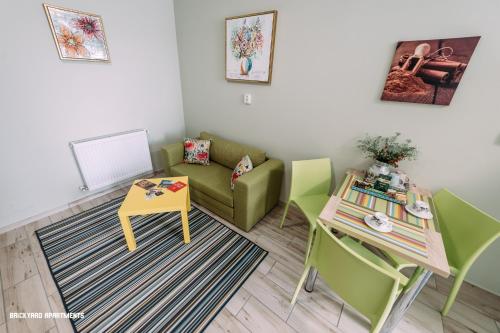 a living room with a couch and a table at Brickyard Apartments Cluj in Cluj-Napoca