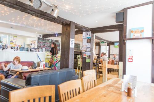 a restaurant with tables and people sitting at tables at Route 2 Apartments in Topsham