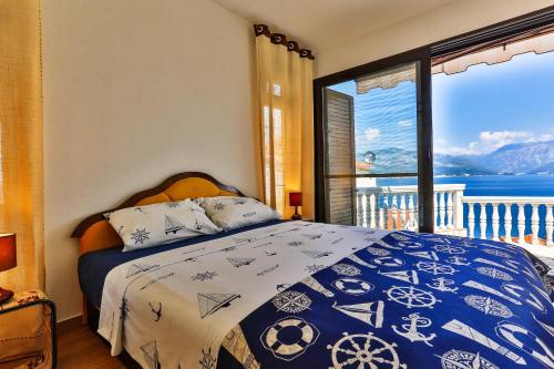 a bedroom with a bed with a view of the ocean at Apartment 365 in Tivat
