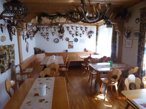 a dining room with tables and chairs and a window at Landgasthaus Gemsennest in Feldberg