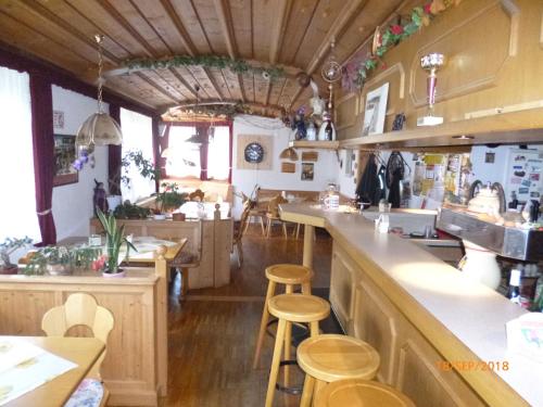 a kitchen with wooden counters and stools at Landgasthaus Gemsennest in Feldberg