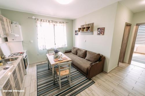 a living room with a couch and a table at Brickyard Apartments Cluj in Cluj-Napoca