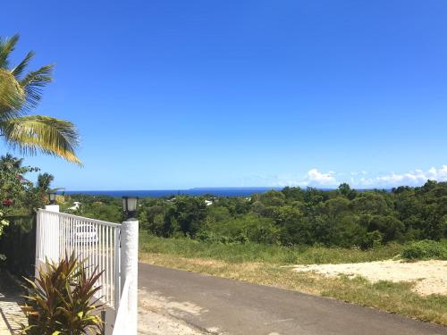 a view of the ocean from a road at Locastudio - Pomme Kanel in Sainte-Anne