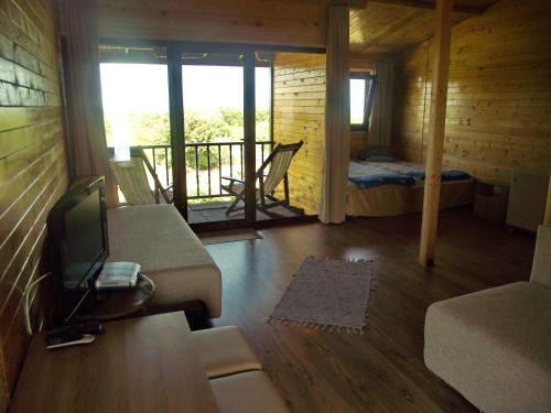 a room with a couch and a bed and a balcony at Lozyata Guest House in Obzor