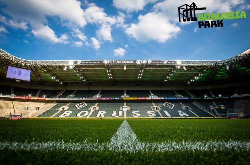 a view of a soccer stadium with a white arrow at H4 Hotel Mönchengladbach im BORUSSIA-PARK in Mönchengladbach